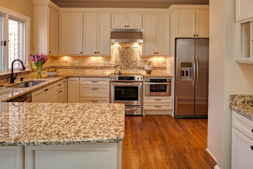 Giallo Napoli with Antique White Cabinets, Red Oak Hardwood Flooring, Stainless Steel Appliance and Polished and Honed Travertine Backsplash and Stone Blend Glass Mosaic Tile